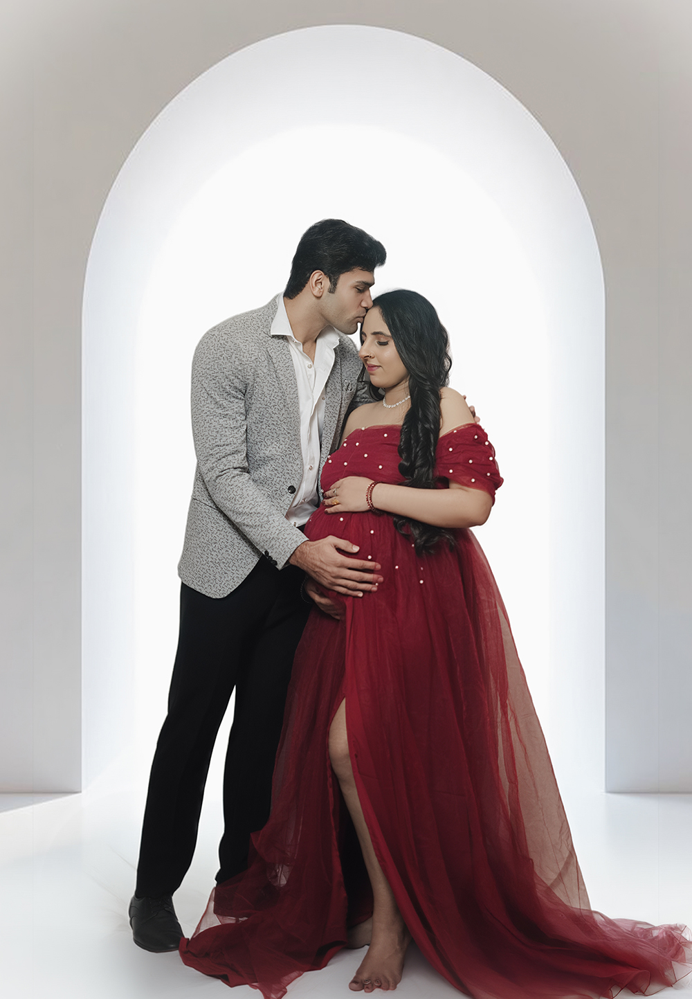 Expecting parents in a red maternity gown